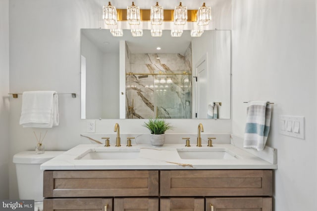 bathroom with a shower with door and vanity