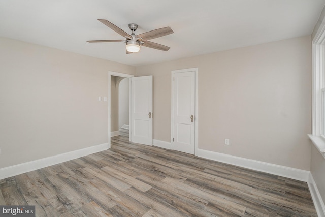 unfurnished bedroom with ceiling fan and wood-type flooring