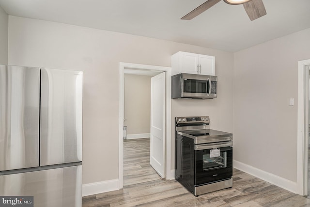 kitchen featuring ceiling fan, appliances with stainless steel finishes, white cabinetry, and light hardwood / wood-style flooring