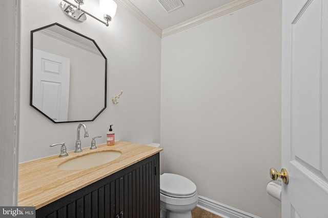 bathroom with ornamental molding, vanity, and toilet