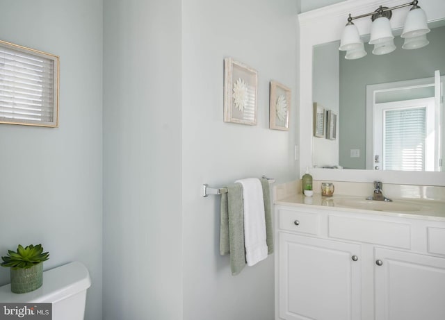 bathroom featuring vanity and toilet