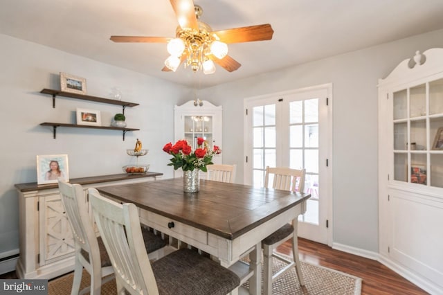 dining area with ceiling fan, baseboards, and dark wood finished floors