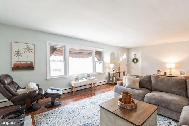 living area featuring a baseboard heating unit and wood finished floors