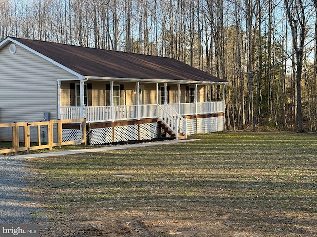 view of front of house with covered porch and a front yard