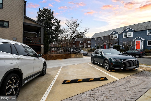 parking at dusk with a residential view and uncovered parking