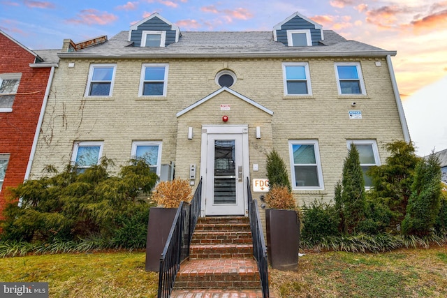 townhome / multi-family property featuring entry steps and brick siding