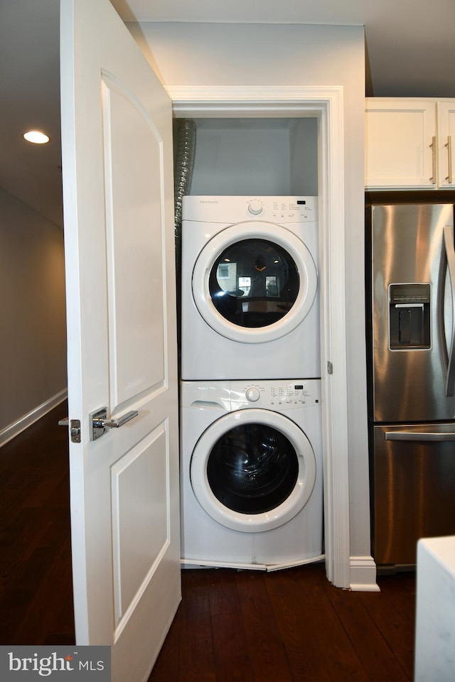 washroom with stacked washer and dryer, recessed lighting, laundry area, and dark wood-style floors