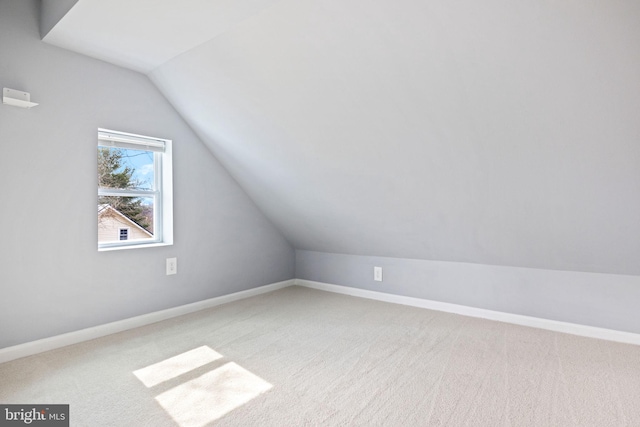 additional living space featuring lofted ceiling, carpet flooring, and baseboards