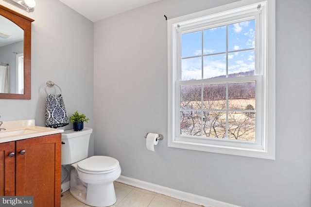 full bathroom with toilet, vanity, baseboards, and tile patterned floors