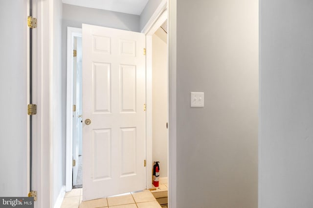 corridor featuring light tile patterned floors