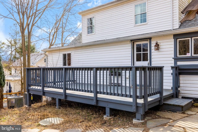 back of property featuring a deck, roof with shingles, and cooling unit