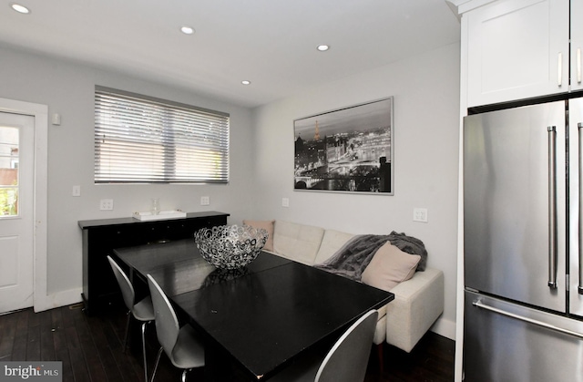 dining room with dark wood-type flooring and plenty of natural light