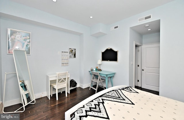 bedroom with dark hardwood / wood-style flooring