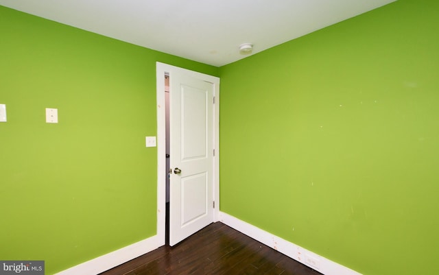 unfurnished room featuring dark hardwood / wood-style floors