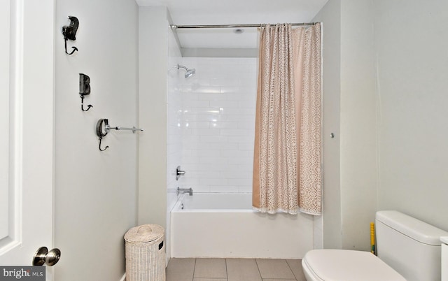 bathroom with shower / tub combo with curtain, tile patterned flooring, and toilet