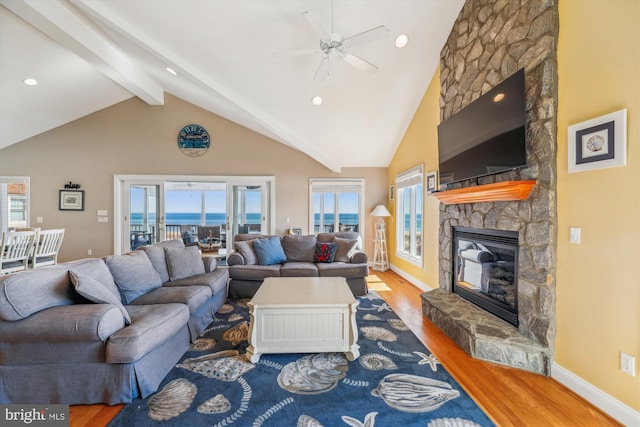 living room with high vaulted ceiling, a fireplace, beamed ceiling, and wood finished floors