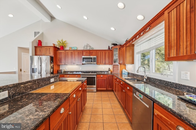 kitchen featuring light tile patterned floors, visible vents, beamed ceiling, stainless steel appliances, and a sink