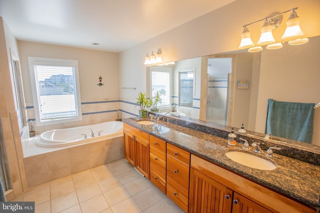 full bathroom with a garden tub, a stall shower, a sink, and tile patterned floors