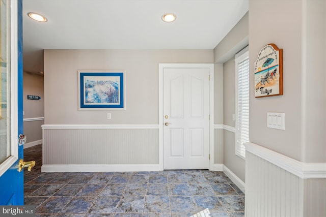 foyer entrance with recessed lighting and baseboards