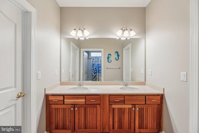 full bathroom featuring double vanity and a sink