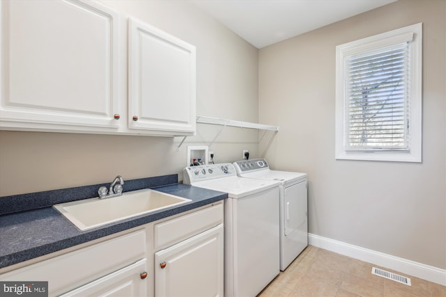 washroom with washer and clothes dryer, cabinet space, visible vents, a sink, and baseboards