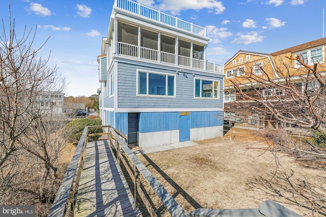 rear view of property featuring a balcony