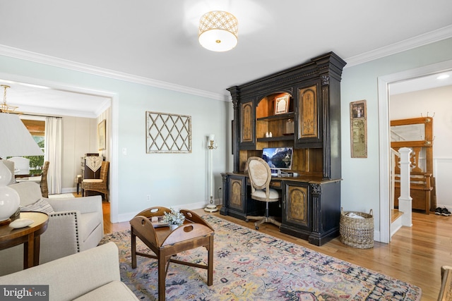 living room featuring baseboards, light wood-style floors, and crown molding