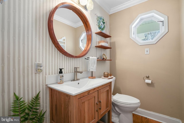 bathroom with ornamental molding, baseboards, vanity, and toilet