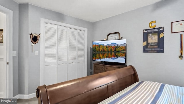 bedroom featuring baseboards and a closet