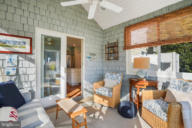 interior space with vaulted ceiling and a ceiling fan