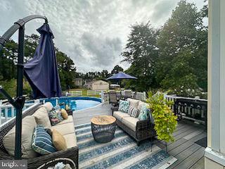 pool with a deck and an outdoor living space