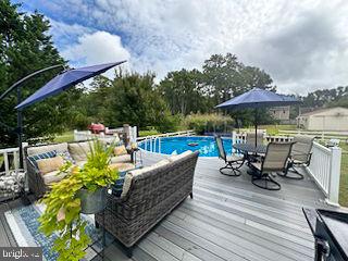 outdoor pool with a wooden deck