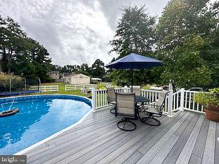 pool featuring a deck and outdoor dining area