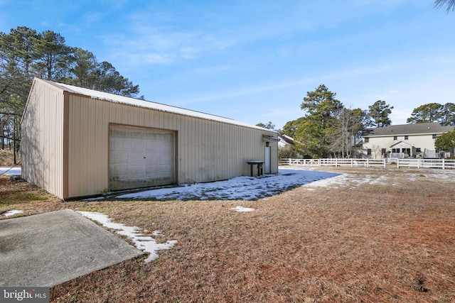 detached garage featuring fence