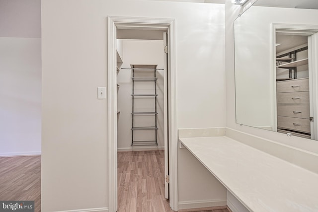 bathroom with baseboards and wood finished floors