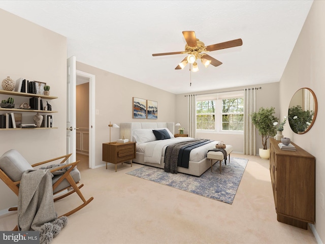 bedroom with light carpet, a ceiling fan, and baseboards