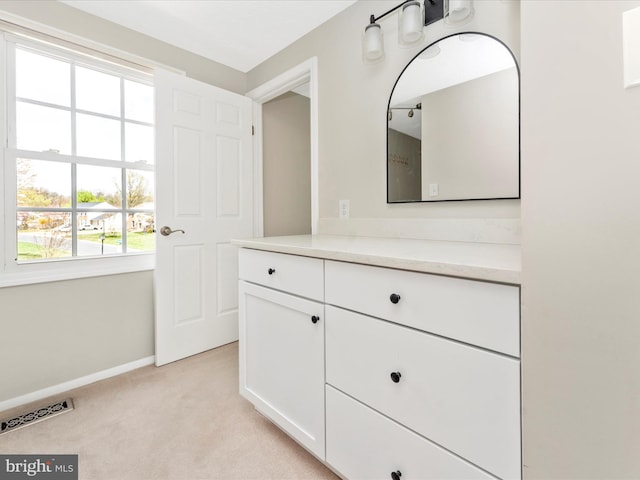 bathroom with baseboards, vanity, and visible vents