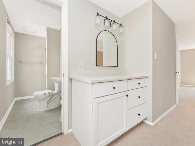 bathroom with baseboards, toilet, and vanity