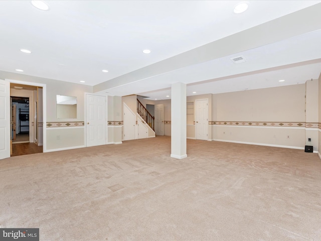 finished below grade area with recessed lighting, stairway, baseboards, and light carpet