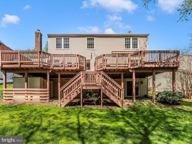 rear view of property with a wooden deck and a yard