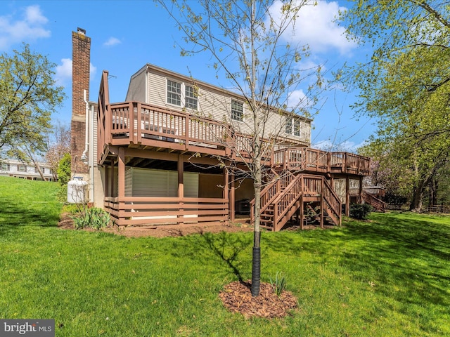rear view of property with a lawn, a chimney, stairs, and a deck