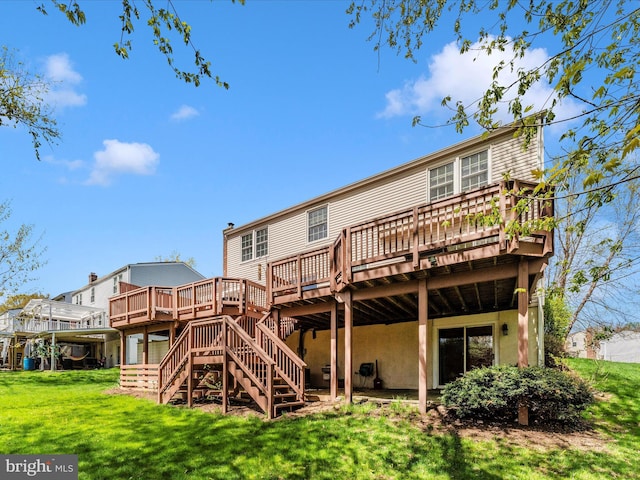 back of property featuring stairway, a yard, and a deck
