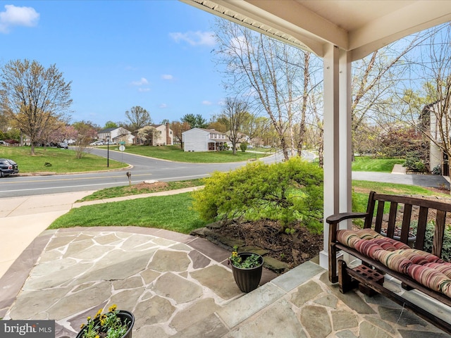 view of patio / terrace featuring a porch and a residential view