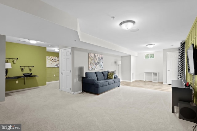 living room featuring light colored carpet and baseboards