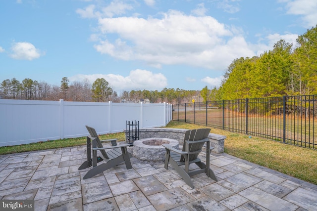 view of patio / terrace featuring an outdoor fire pit and a fenced backyard