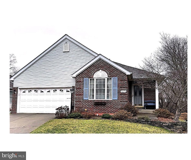 view of front of house featuring a garage and a front lawn