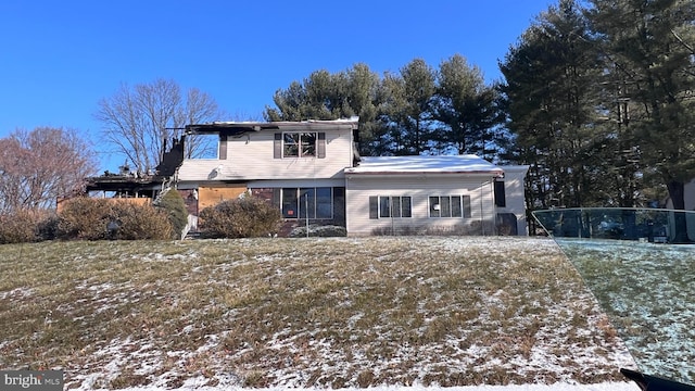 view of snow covered rear of property