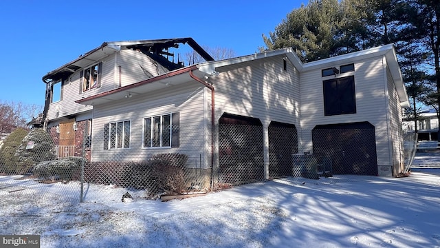 snow covered property featuring a garage