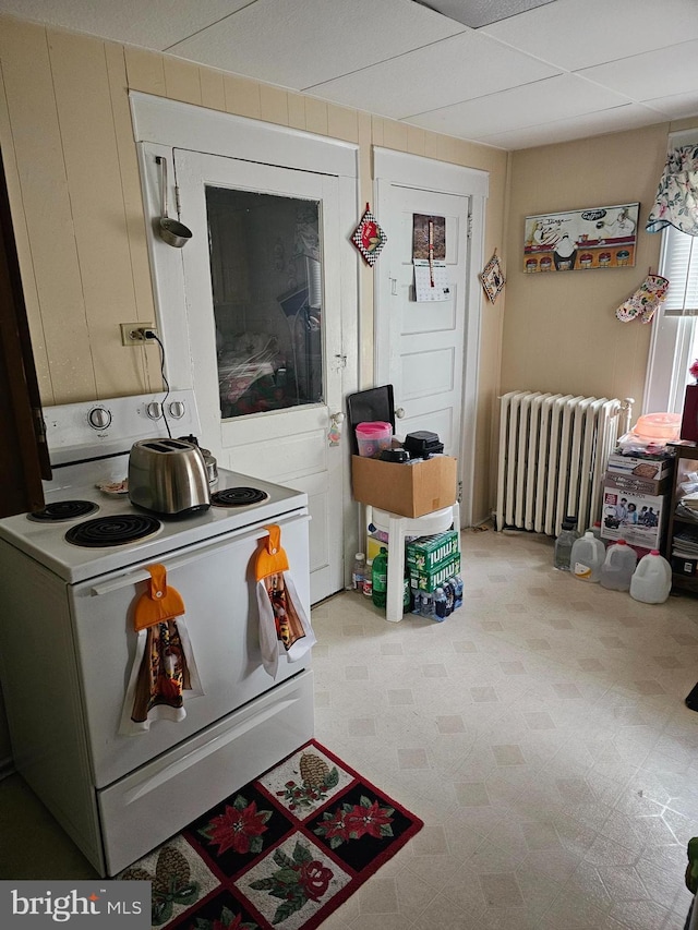 laundry room featuring light floors and radiator heating unit