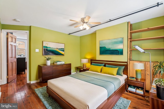 bedroom featuring dark wood-type flooring and ceiling fan